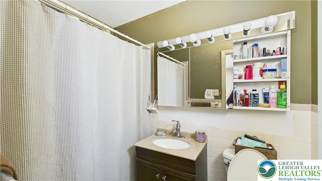 4168 Orefield Rd, South Whitehall Twp, PA 18104 - full bath with toilet, vanity, backsplash, and tile walls