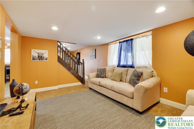living area featuring wood finished floors, stairs, recessed lighting, and baseboards