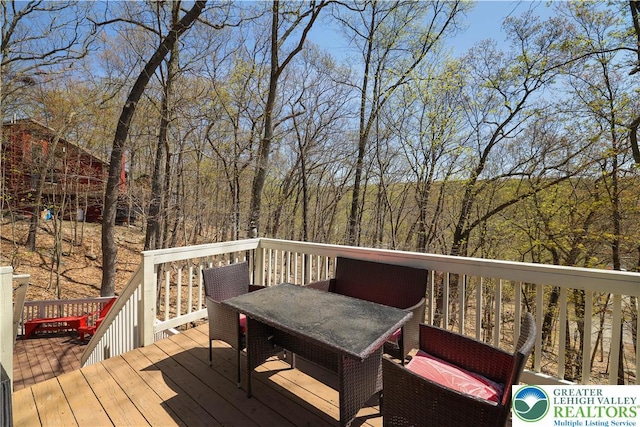 wooden terrace featuring outdoor dining space