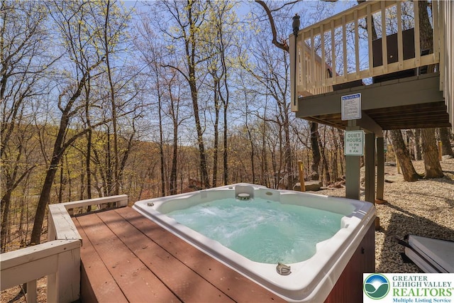 deck with an outdoor hot tub