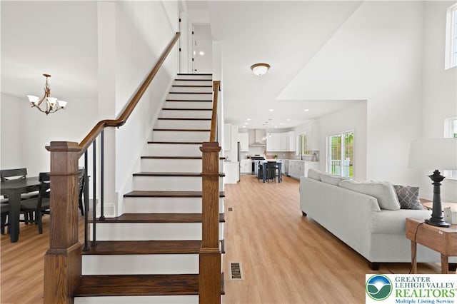 4779 Farrcroft Dr Unit 90, Forks Twp, PA 18040 - stairs featuring wood finished floors, a chandelier, a high ceiling, and recessed lighting