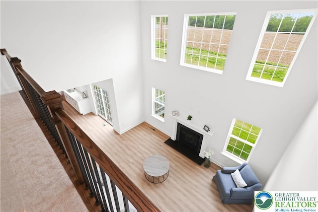 4779 Farrcroft Dr Unit 90, Forks Twp, PA 18040 - living area with a towering ceiling, a fireplace, baseboards, and wood finished floors