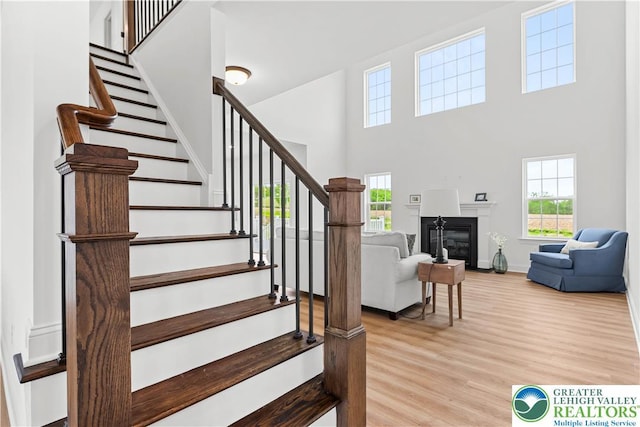 4779 Farrcroft Dr Unit 90, Forks Twp, PA 18040 - stairway with a high ceiling, healthy amount of natural light, wood finished floors, baseboards, and a glass covered fireplace