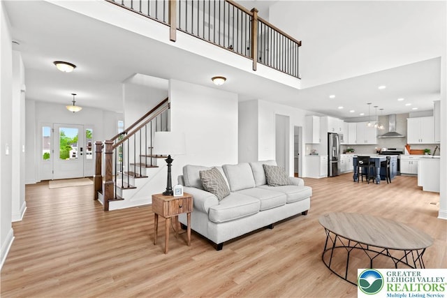 4779 Farrcroft Dr Unit 90, Forks Twp, PA 18040 - living area featuring light wood-type flooring, a high ceiling, stairway, recessed lighting, and baseboards