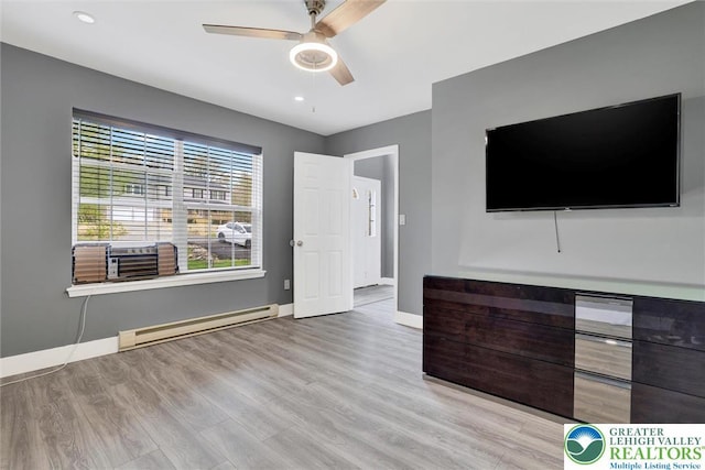 959 Cricket, Tunkhannock Township, PA 18334 - unfurnished living room with a baseboard radiator, baseboards, light wood-type flooring, cooling unit, and a ceiling fan