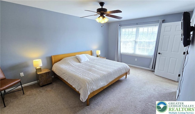 bedroom with light carpet, baseboards, and ceiling fan