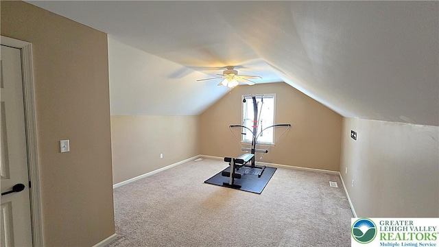 workout area with carpet, baseboards, vaulted ceiling, and a ceiling fan