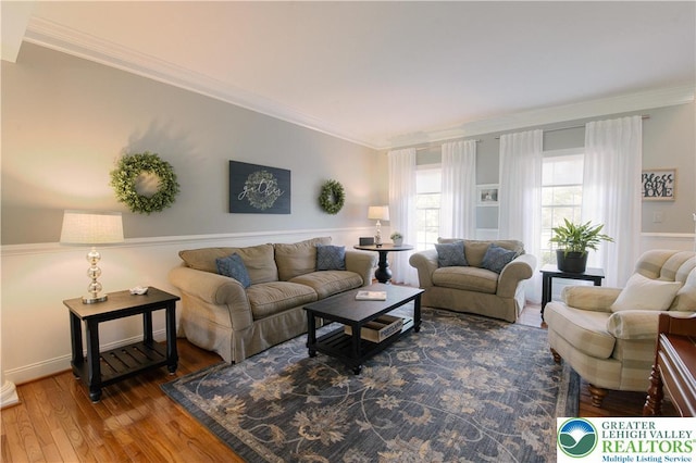 living room with ornamental molding and wood finished floors