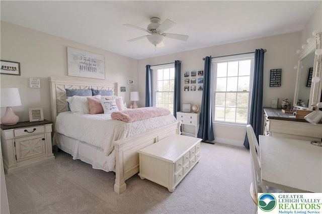 bedroom with light carpet, baseboards, and ceiling fan