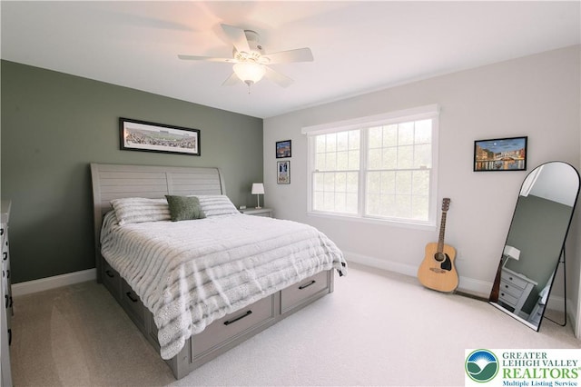 bedroom featuring light colored carpet, baseboards, and ceiling fan