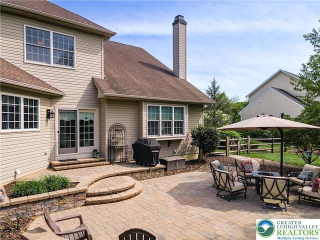 view of patio with an outdoor living space with a fire pit, fence, entry steps, and a grill