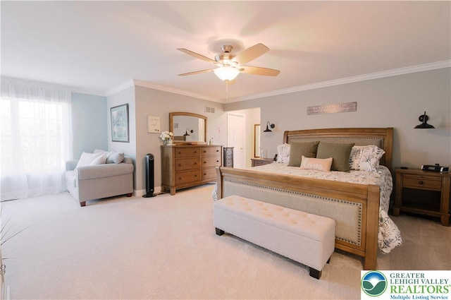 bedroom featuring ornamental molding, light colored carpet, and a ceiling fan