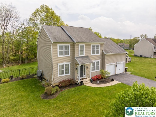 view of front of house with central AC unit, asphalt driveway, and an attached garage