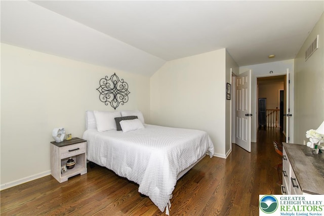 bedroom with baseboards, dark wood-style flooring, and vaulted ceiling