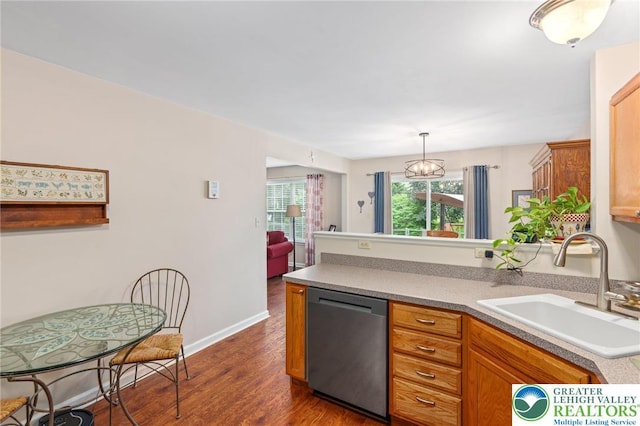 kitchen featuring stainless steel dishwasher, a sink, dark wood-style flooring, a peninsula, and baseboards