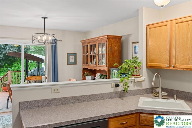 kitchen featuring a sink, a chandelier, and hanging light fixtures