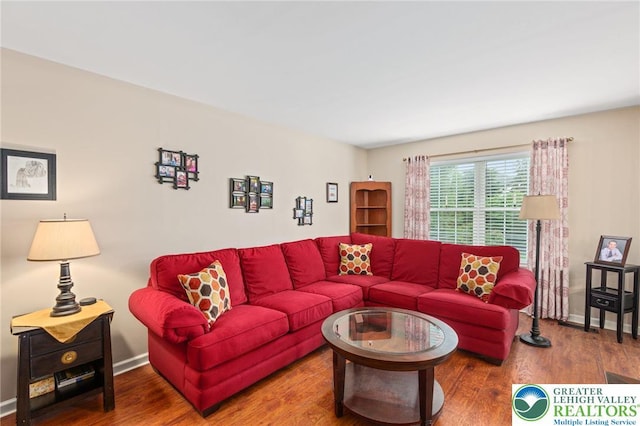 living room with wood finished floors and baseboards