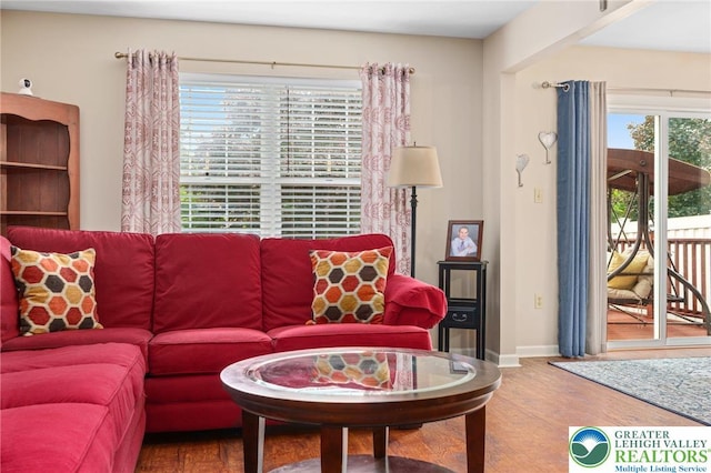 living area with wood finished floors and baseboards