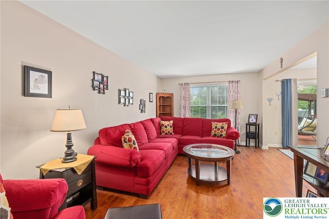 living area with wood finished floors and baseboards