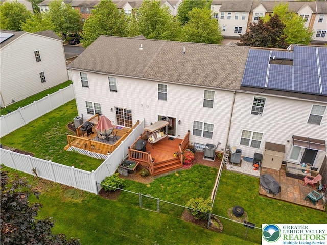 rear view of property with a deck, central AC unit, outdoor dining area, a residential view, and roof with shingles