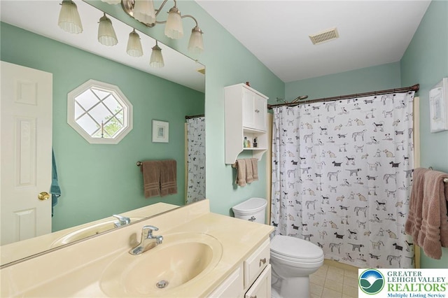 bathroom featuring toilet, vanity, tile patterned flooring, and a shower with curtain
