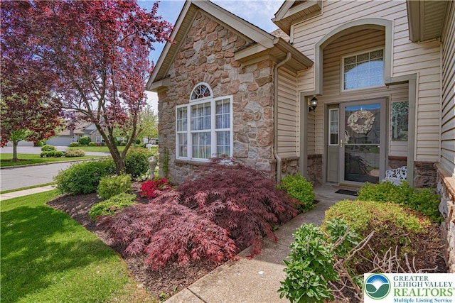property entrance with stone siding