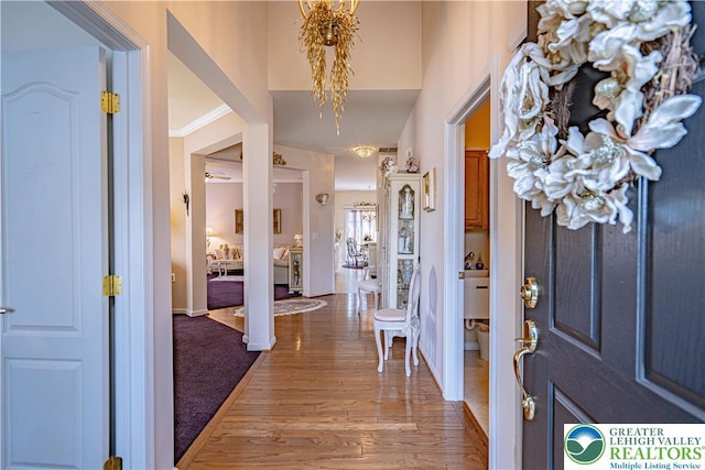 entrance foyer with light wood-style flooring and a chandelier