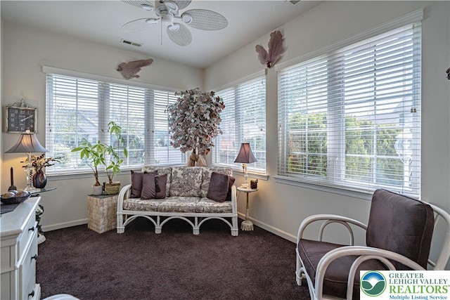 sunroom featuring carpet flooring and baseboards