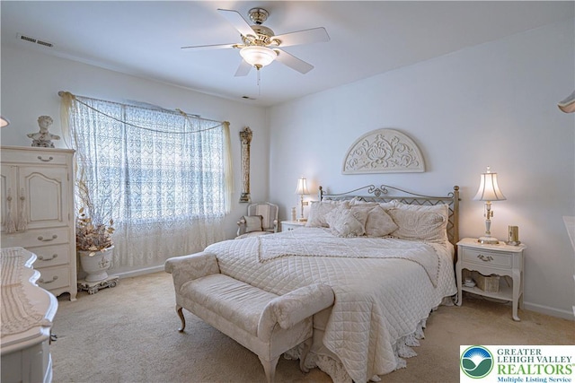 bedroom with light carpet, a ceiling fan, and baseboards