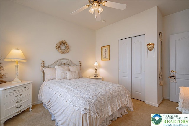 bedroom with light colored carpet, a closet, baseboards, and ceiling fan