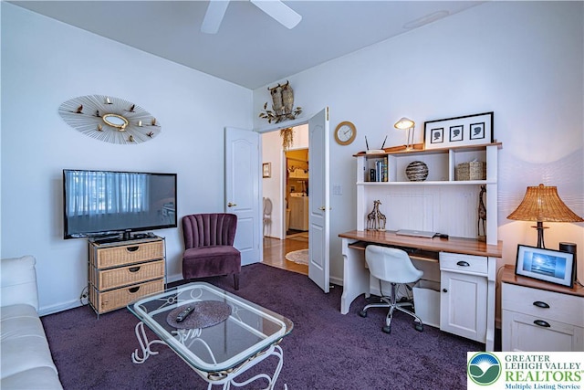 home office with dark colored carpet and ceiling fan