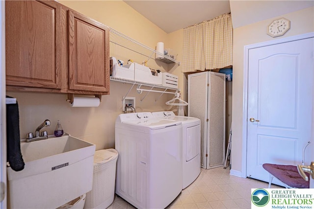 laundry room featuring independent washer and dryer, light flooring, and cabinet space