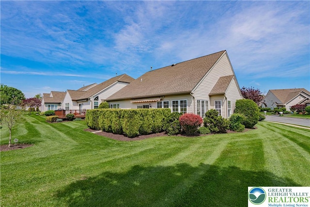 rear view of property with a lawn