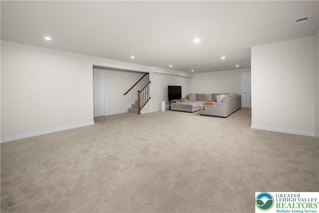 unfurnished living room with recessed lighting, stairway, light colored carpet, and baseboards
