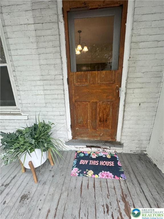 property entrance featuring brick siding