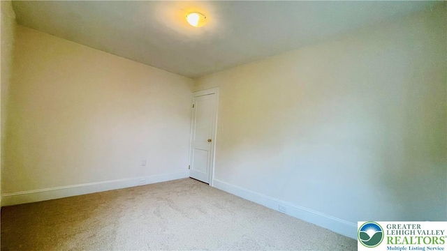 spare room with carpet flooring and baseboards