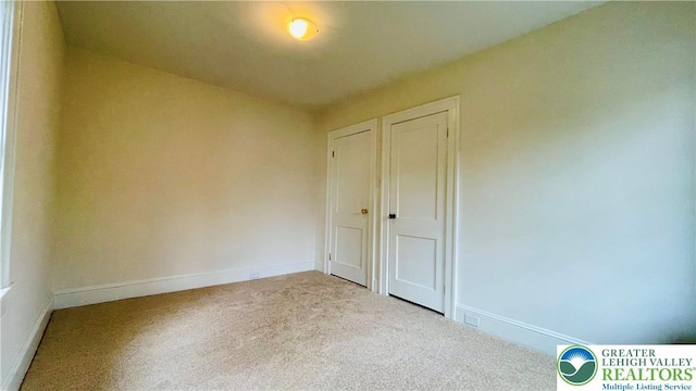 spare room with carpet flooring and baseboards