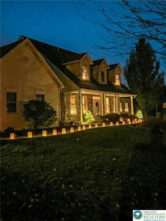 view of front of home featuring a front yard and a porch
