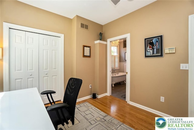 office area featuring light wood finished floors and baseboards