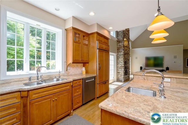 kitchen featuring a sink, stainless steel dishwasher, backsplash, open floor plan, and lofted ceiling