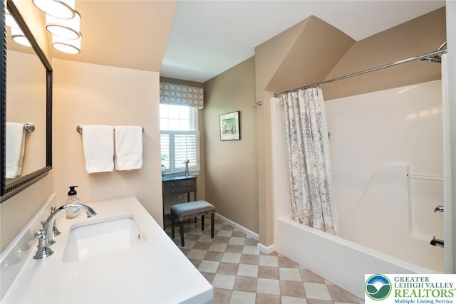 bathroom with a sink, tile patterned floors, shower / bath combination with curtain, and baseboards