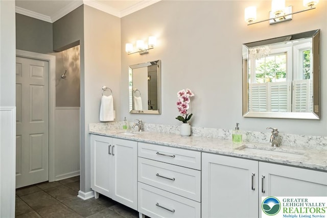 bathroom with crown molding, double vanity, and tile patterned floors