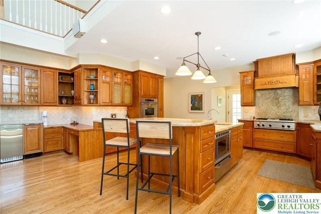 kitchen featuring stainless steel appliances, brown cabinets, decorative backsplash, and recessed lighting