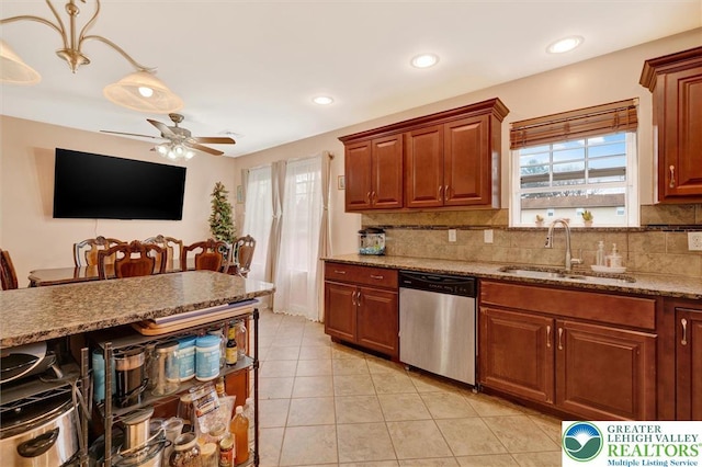 kitchen featuring dishwasher, a sink, a ceiling fan, backsplash, and light tile patterned floors