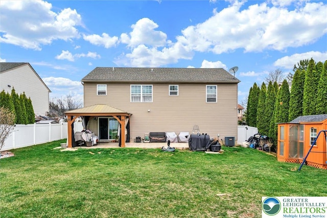 rear view of house featuring a gazebo, a patio area, central AC, and an outbuilding