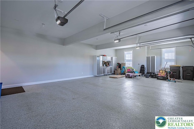 garage with baseboards and a garage door opener