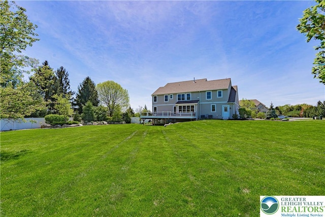 rear view of property featuring a deck