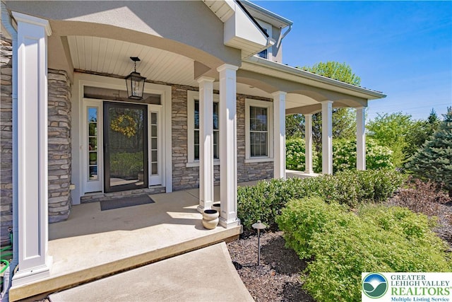 property entrance with stone siding and covered porch