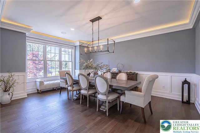 dining room with a wainscoted wall, a decorative wall, dark wood finished floors, and recessed lighting