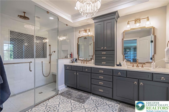 bathroom with tile patterned floors, a stall shower, double vanity, a chandelier, and recessed lighting